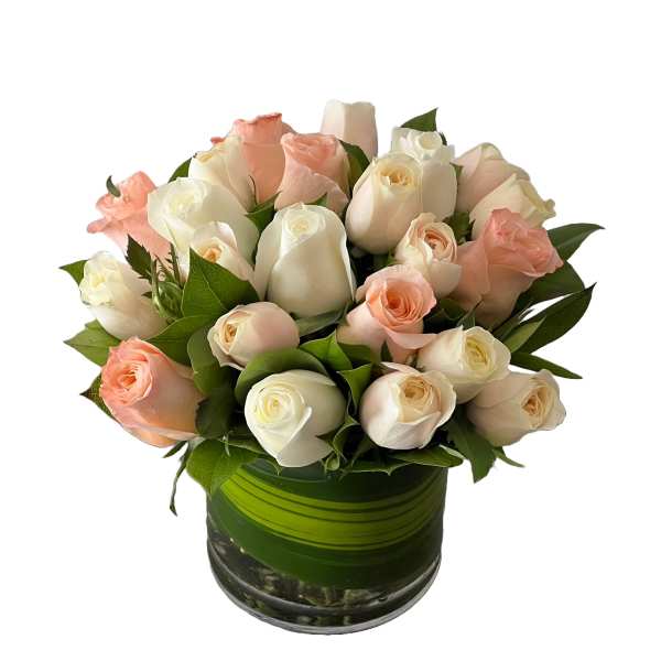 Bouquet of pale pink and white roses in a green glass vase
