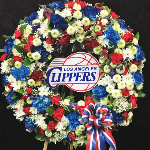 Large floral wreath with a Los Angeles Clippers sign and red, white, and blue ribbon