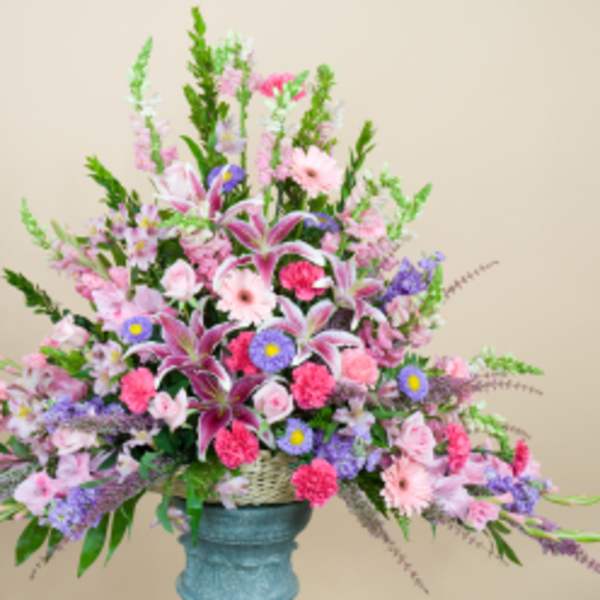 Large pastel floral arrangement in a blue vase
