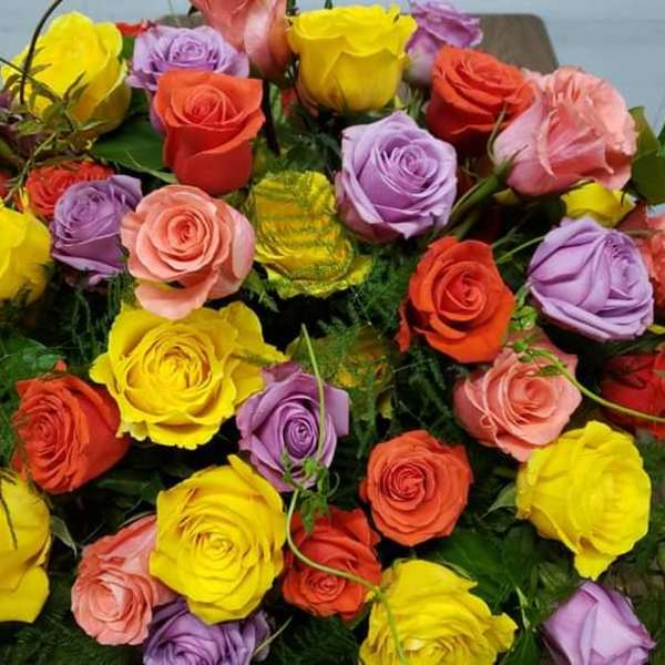 Bouquet of multicolored roses with green filler