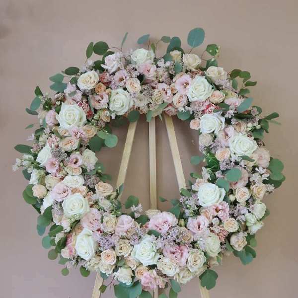 Pastel floral wreath on a wooden easel