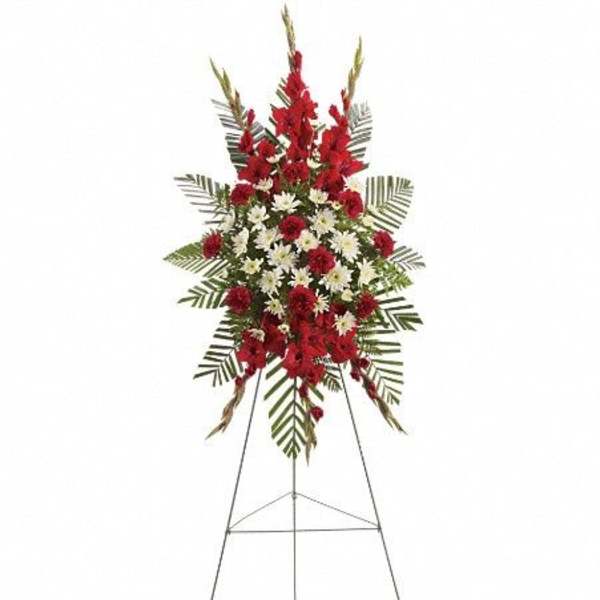 Standing floral spray with red and white flowers on an easel