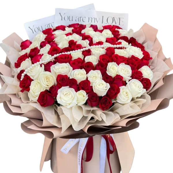Bouquet of red and white roses with a pearl strand and love cards