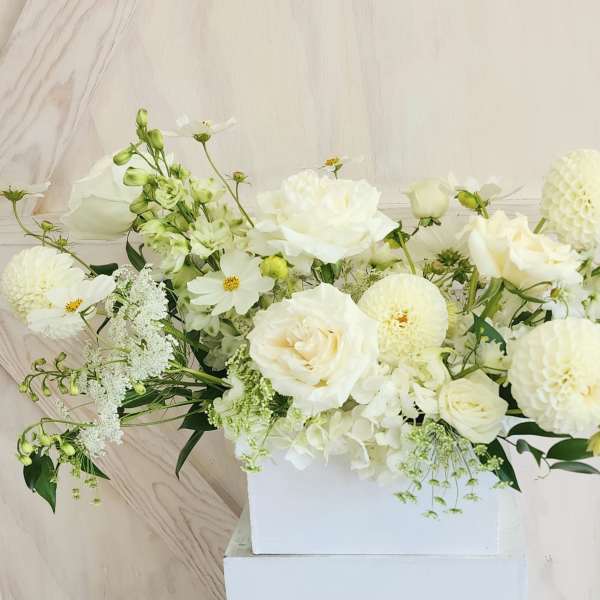 White floral arrangement in a rectangular white box