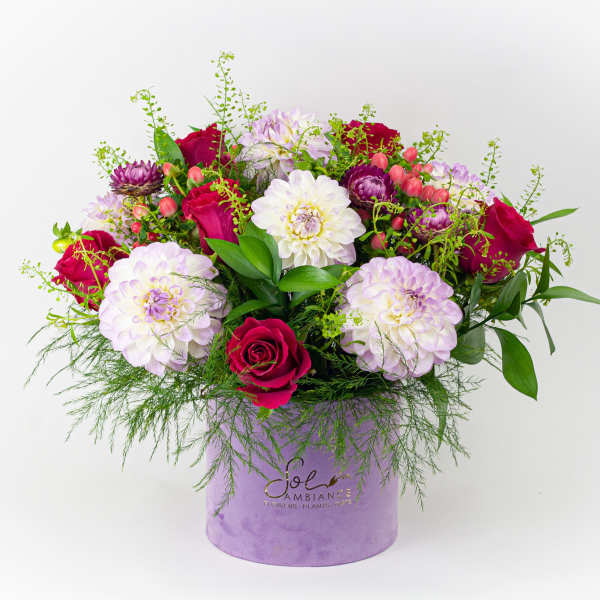 Mixed bouquet of pink and white flowers in a lavender hat box