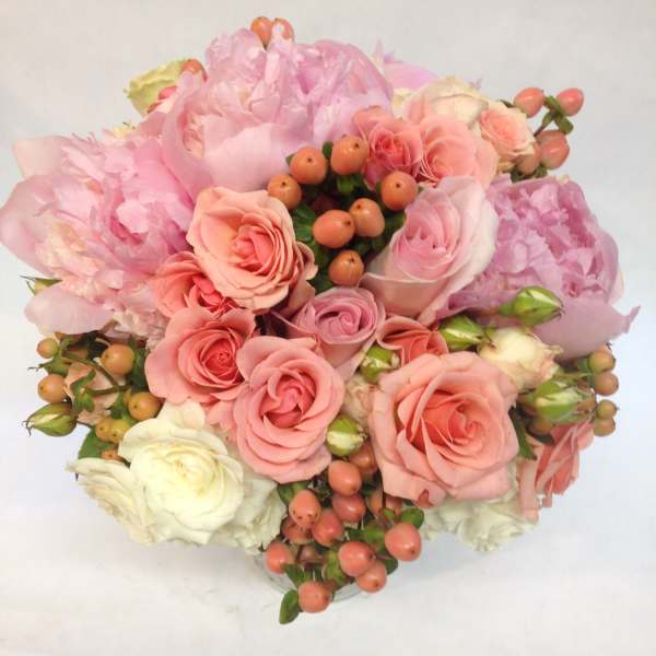 Pink and peach rose bouquet with pale peonies and berry accents