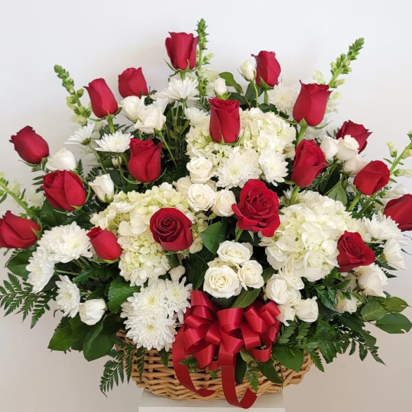 Basket arrangement of red and white roses with white chrysanthemums