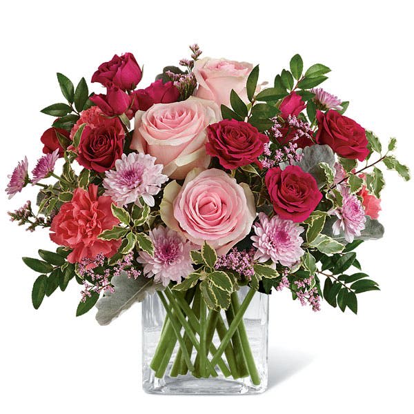 Pink and red rose bouquet in a clear glass vase