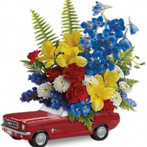Red toy car holding a colorful flower arrangement