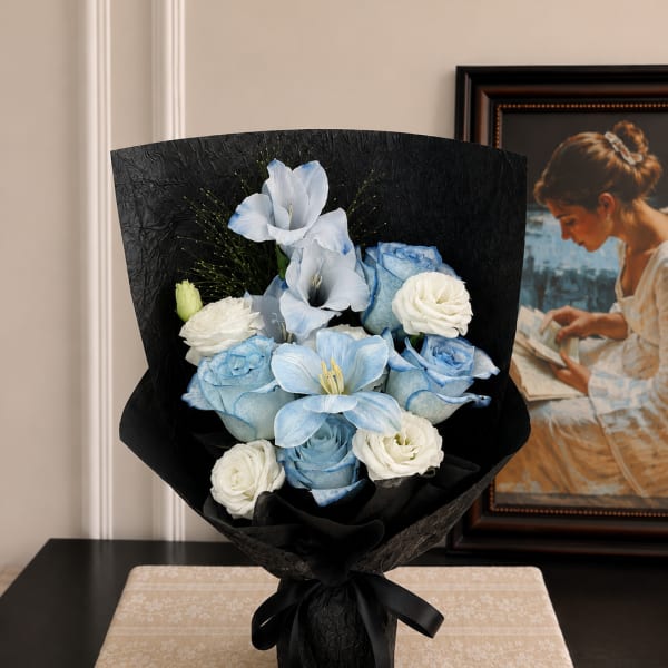 Blue and white bouquet wrapped in black paper with a ribbon