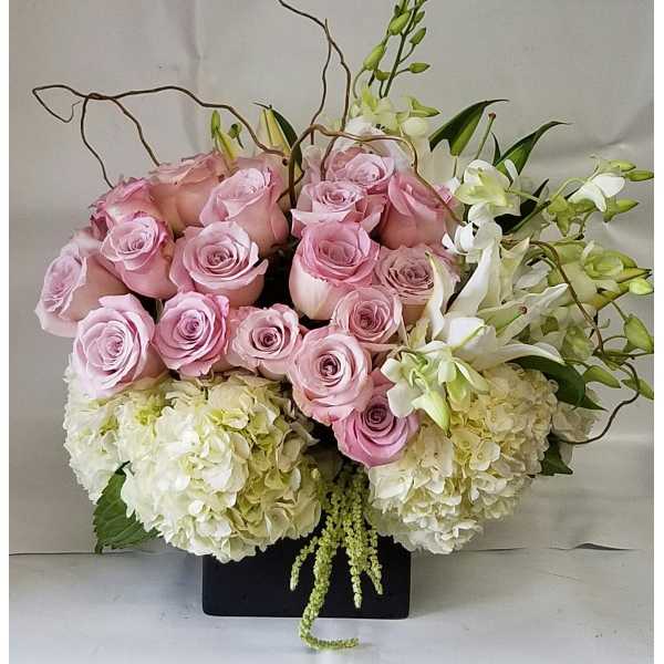 Pink roses and white hydrangeas in a black rectangular vase