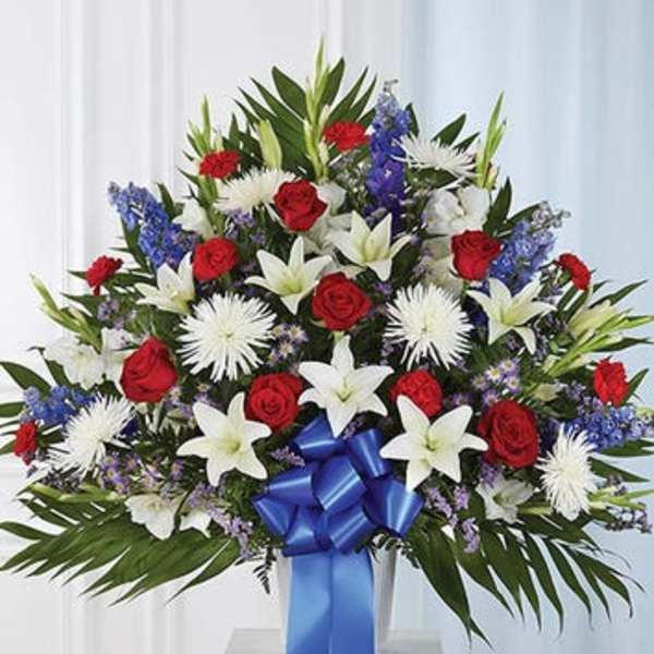 Large bouquet of red roses and white lilies with blue ribbon