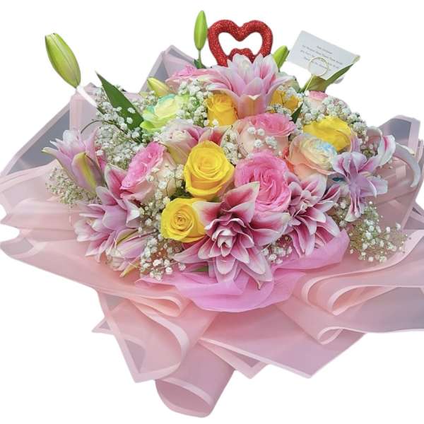 Pink and yellow bouquet with roses and lilies wrapped in pink paper