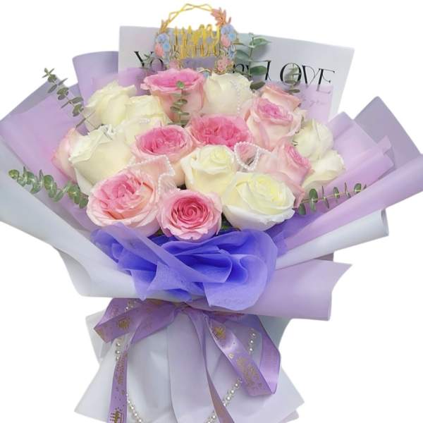 Bouquet of pink and white roses wrapped in lavender paper