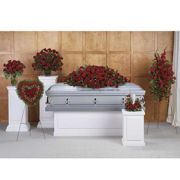 Red rose funeral casket spray with matching standing arrangements