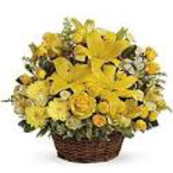 Yellow flower arrangement in a wicker basket