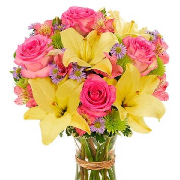 Pink roses and yellow lilies in a glass vase