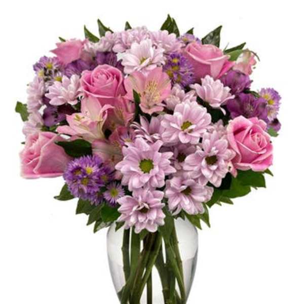 Pink and purple mixed bouquet in a clear glass vase