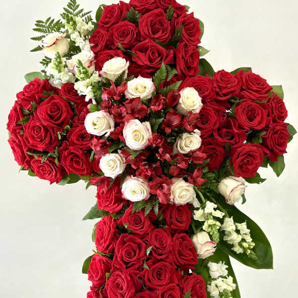 Large cross-shaped arrangement of red and white roses