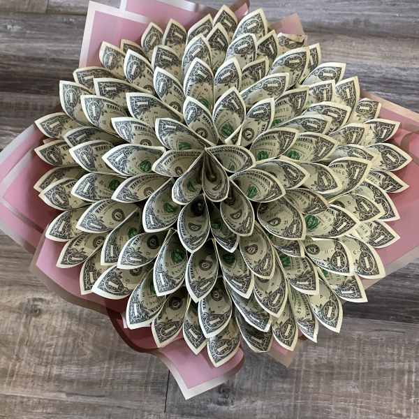 Bouquet made of folded dollar bills with pink wrapping paper