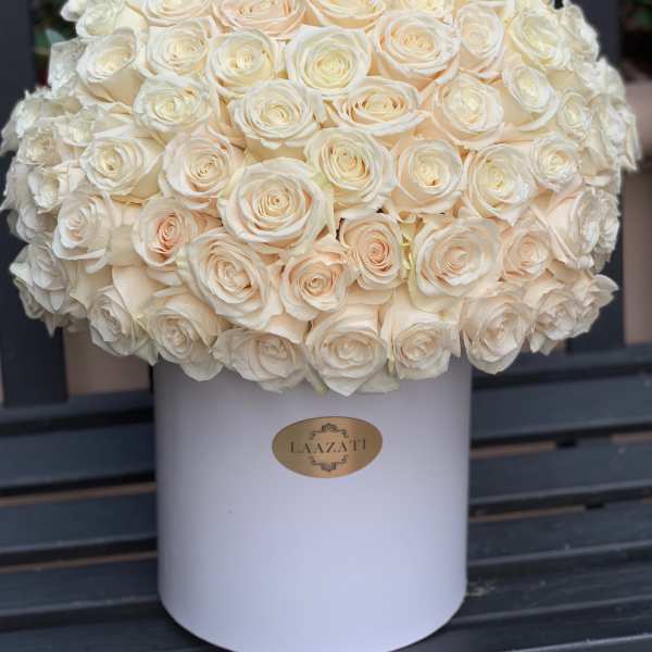 Large bouquet of cream roses in a white hatbox
