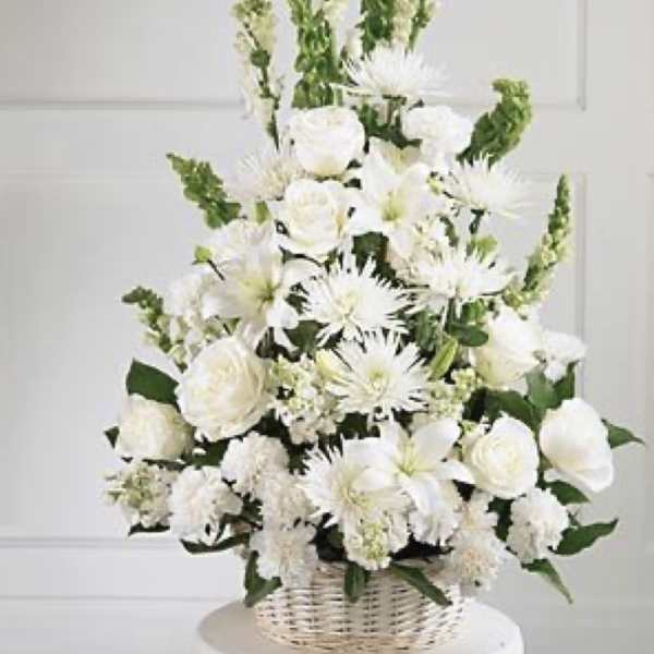 White floral arrangement in a wicker basket