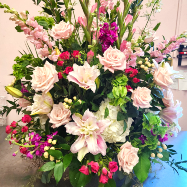 Large mixed flower arrangement with pink roses and lilies