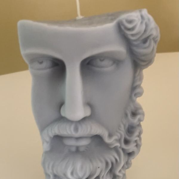 Gray sculpted candle shaped like a bearded face