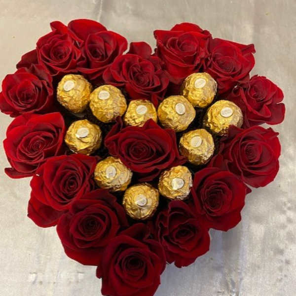 Heart-shaped bouquet of red roses with gold-wrapped chocolates