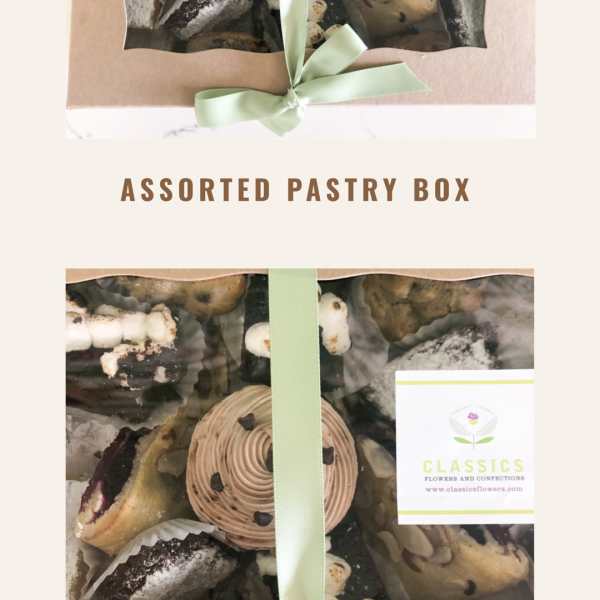 Box of assorted pastries tied with a pale green ribbon
