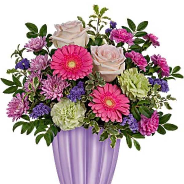 Pink and white flowers arranged in a purple vase