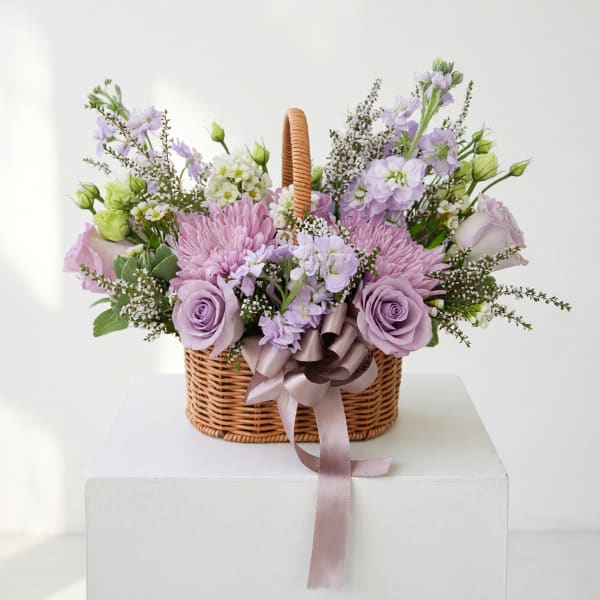 Lavender and pink flower basket with a ribbon bow
