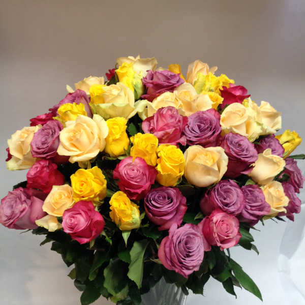 Mixed-color rose bouquet in a clear glass vase