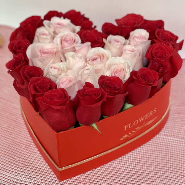 Heart-shaped box of red and pale pink roses