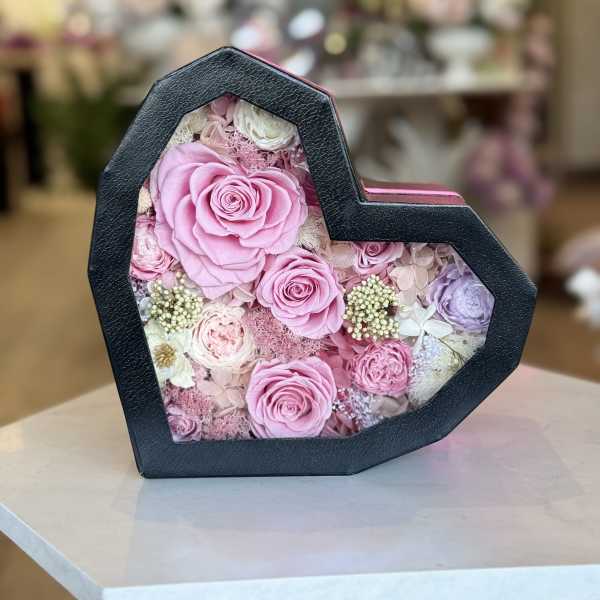 Beautiful preserved flowers and necklace in heart box