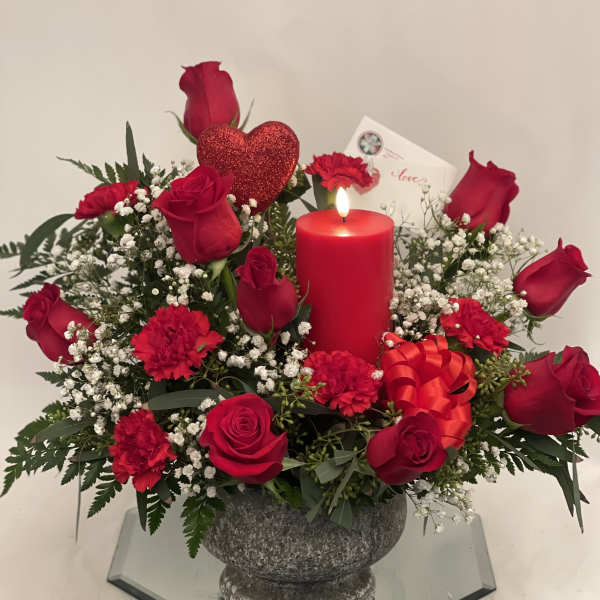 Red rose arrangement with a candle and glitter heart in a stone vase
