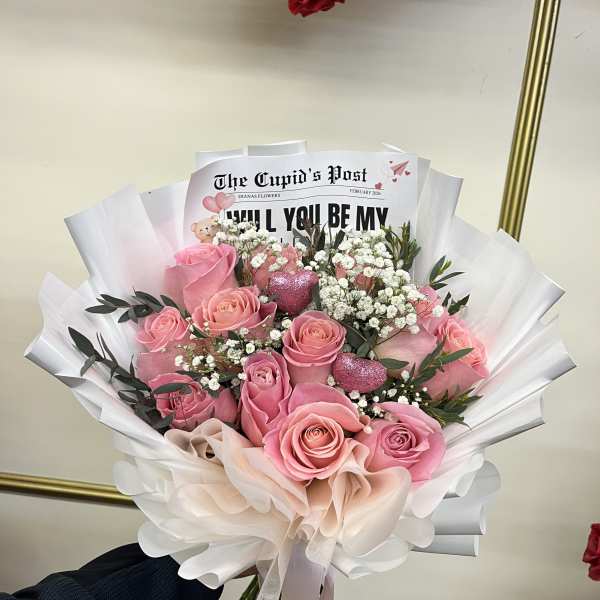 Pink rose bouquet with white baby's breath and paper wrapping