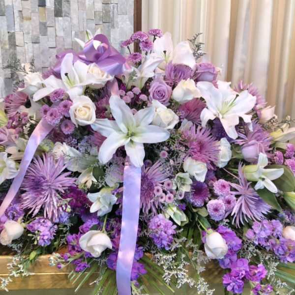Large lavender and white floral spray with lilies and roses