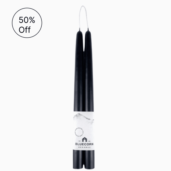 Pair of black taper candles joined by one wick with a Bluecorn label around the base