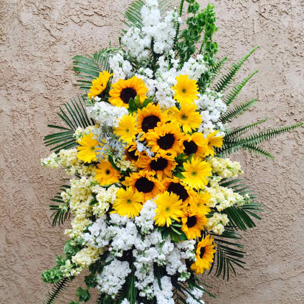Standing floral spray with yellow sunflowers and white blooms
