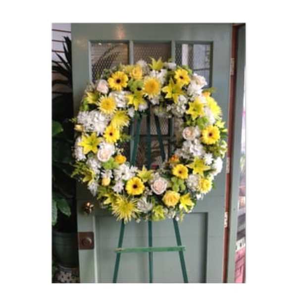 Yellow and white floral wreath on an easel