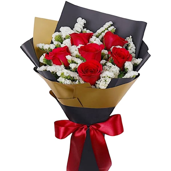 Bouquet of red roses with white filler flowers wrapped in black and gold paper