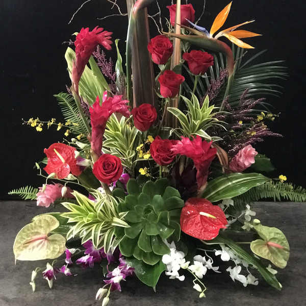 Tall tropical arrangement with red roses, anthuriums, and bird of paradise