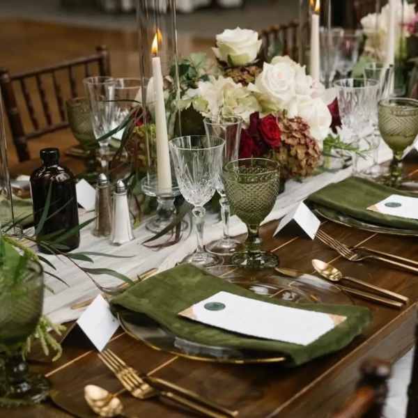 Floral table centerpiece with white and red roses on a set dining table