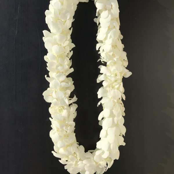White flower lei on a dark background