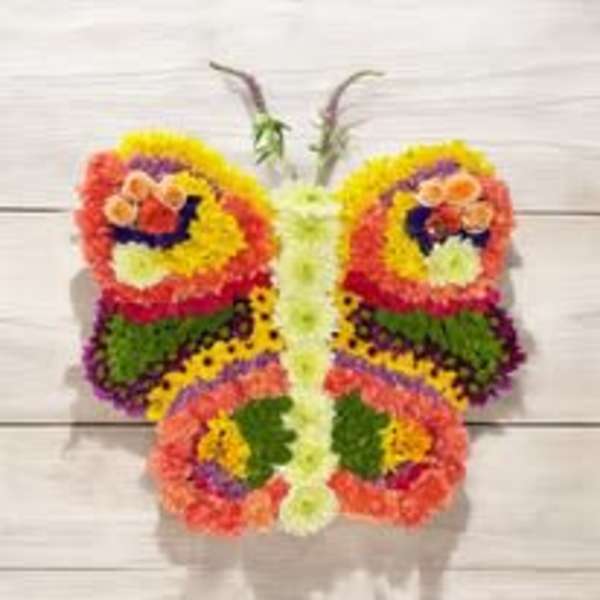 Butterfly-shaped floral arrangement with bright multicolored blooms
