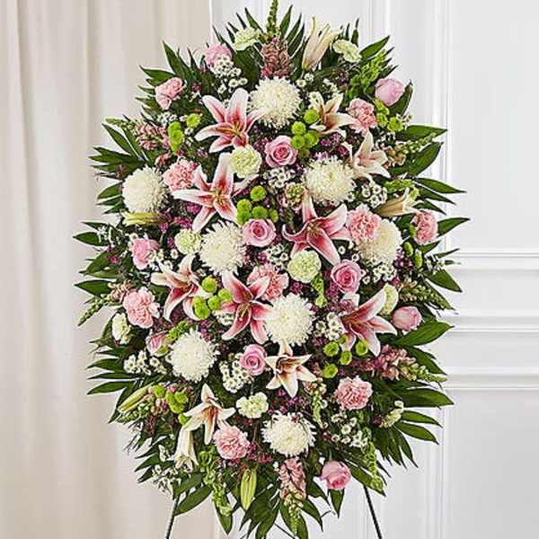 Standing floral spray with pink lilies, roses, and white mums