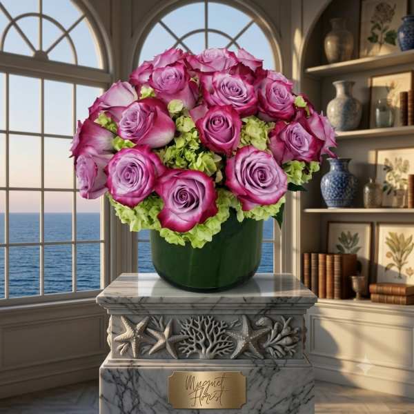 Pink and lavender roses arranged in a green vase with pale green flowers