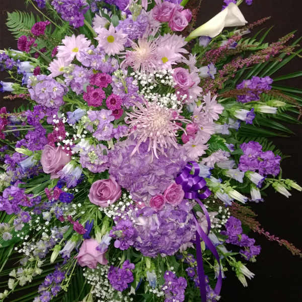 Large purple and pink floral spray with calla lilies and roses