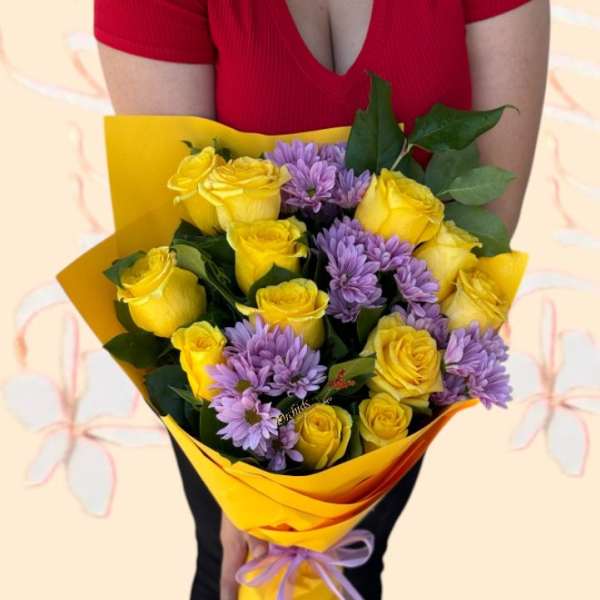 Bouquet of yellow roses and purple daisies wrapped in yellow paper